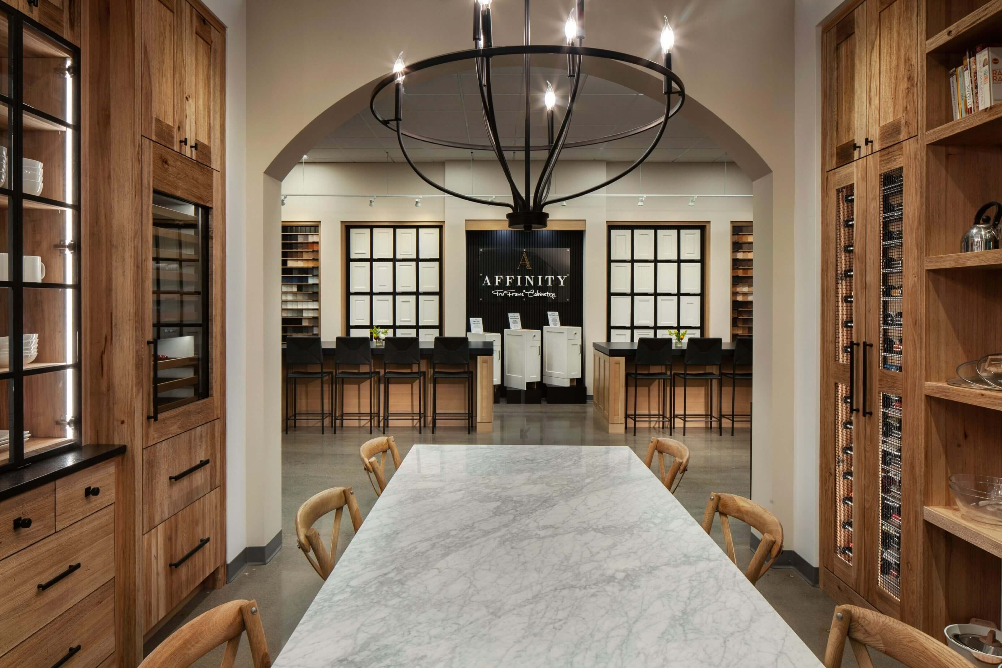 Modern kitchen showroom with wooden cabinetry.