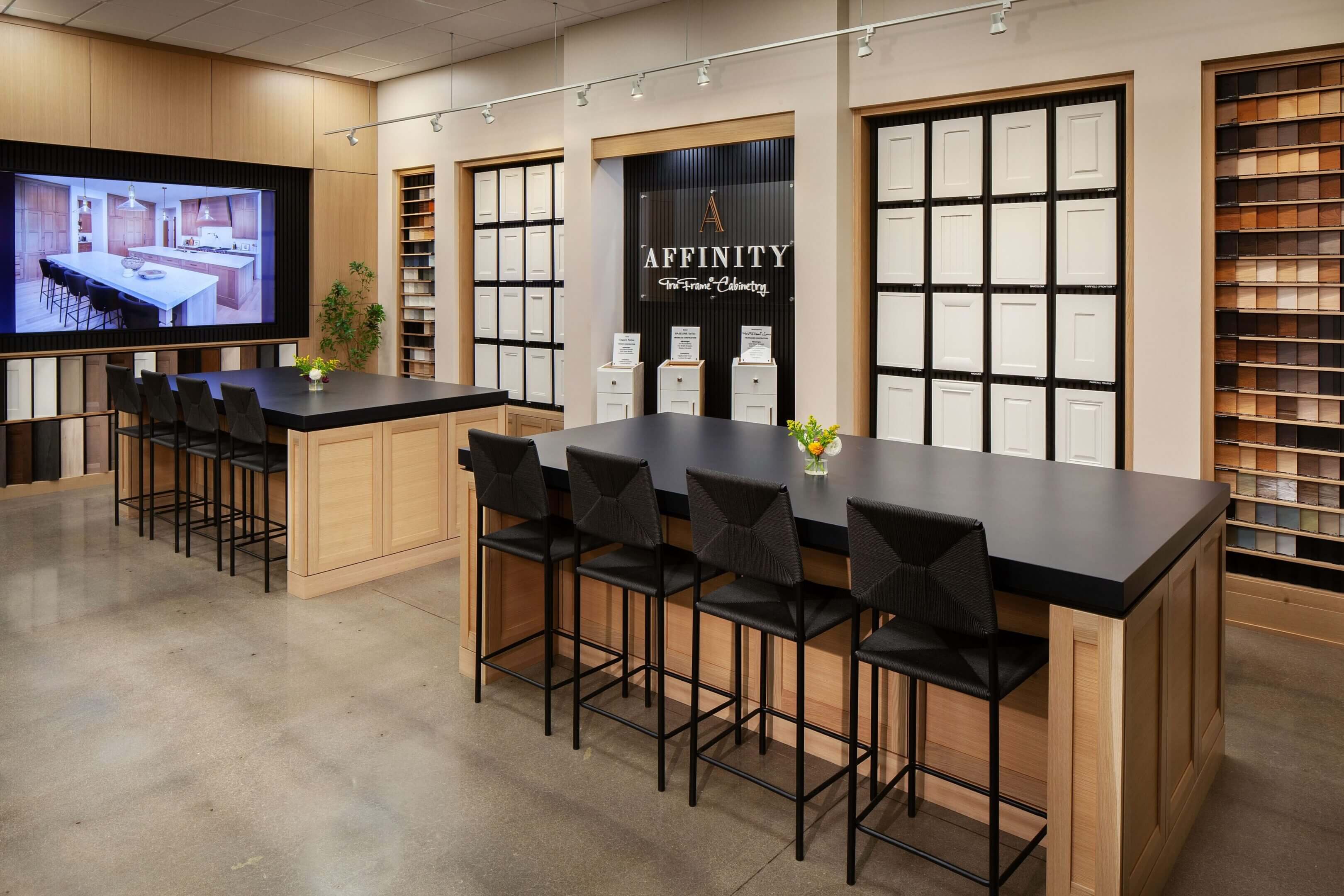 Modern showroom with tables and display walls.