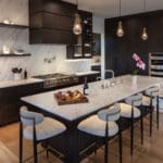 Modern kitchen with marble island and bar stools