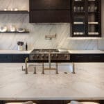 Modern marble kitchen island with brass faucet
